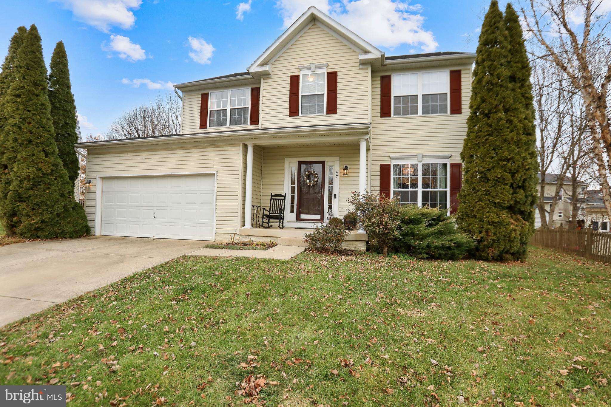 a view of a white house with a yard and plants