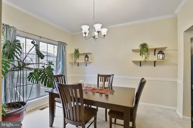 a bedroom with a large bed and a chandelier fan