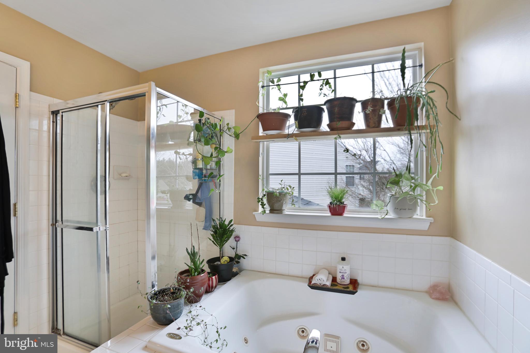 97 Webb Court Frederick, MD 21702 - Photo 24 of 34 a bathroom with a tub and a window