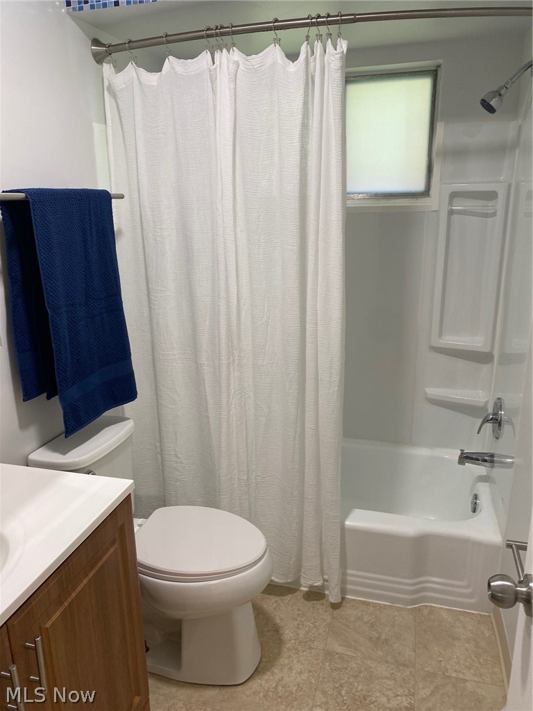 597 Baldwin Road Akron, OH 44312 - Photo 15 of 17 Full bathroom with tile patterned flooring, shower / bath combo, toilet, and vanity