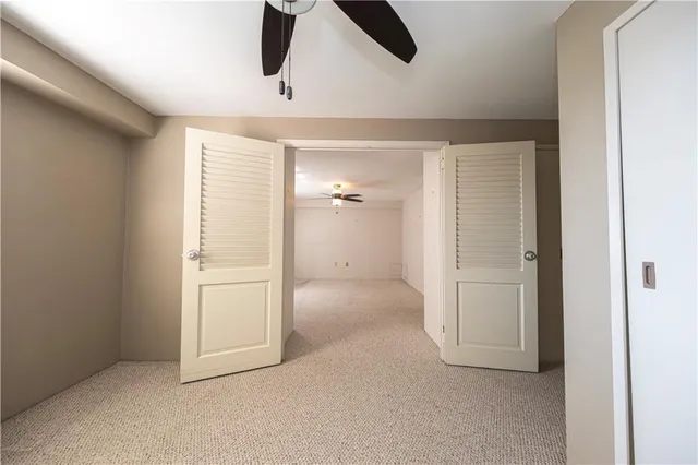 a view of a livingroom with a ceiling fan and window