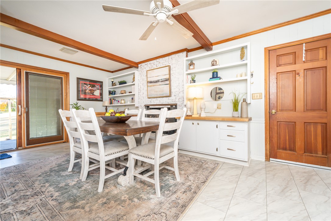 401 South Glassy Mountain Road Pickens, SC 29671 - Photo 23 of 37 This inviting dining area features elegant wood beams and built-in shelving, creating a warm and organized atmosphere.