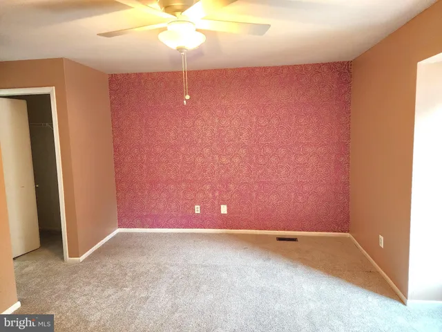 an empty room with a fan