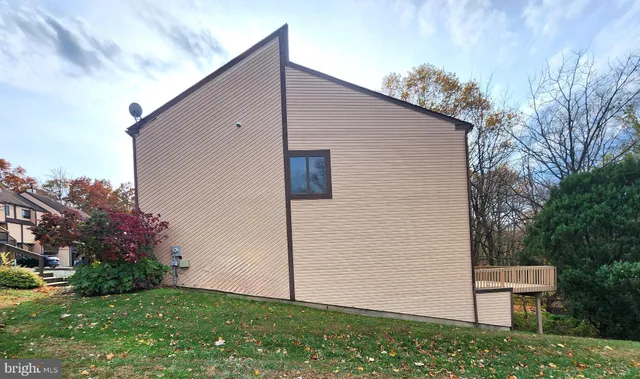 a backyard of a house with plants and tree