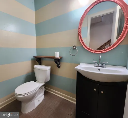 a bathroom with a toilet a sink and a mirror