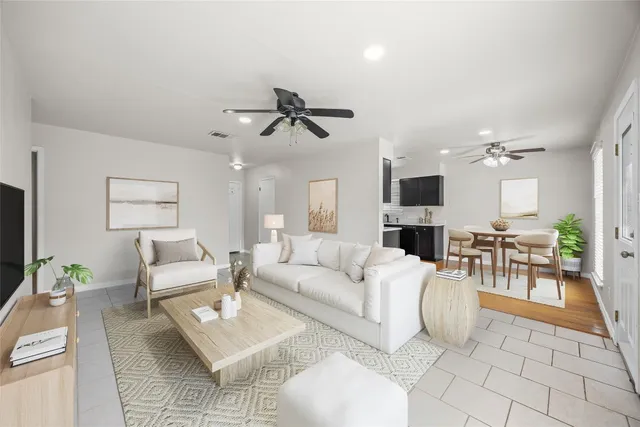 a living room with furniture a table and a flat screen tv