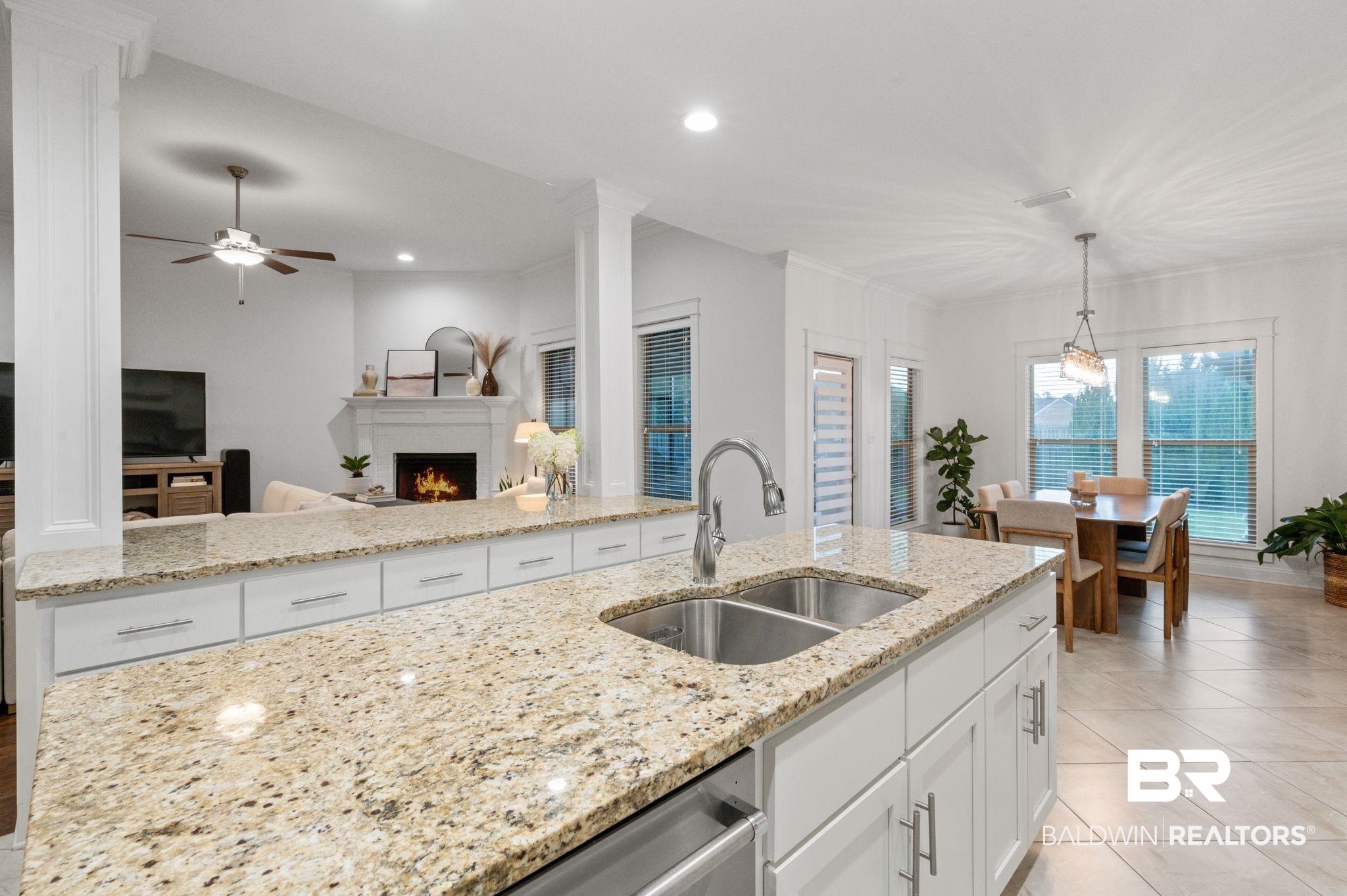 418 Fortune Drive Fairhope, AL 36532 - Photo 15 of 63 Kitchen with ceiling fan, hanging light fixtures, sink, light stone counters, and light tile patterned floors