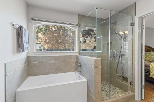 a bathroom with a bathtub and a shower