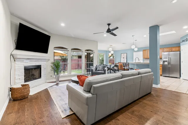 a living room with furniture fireplace and flat screen tv