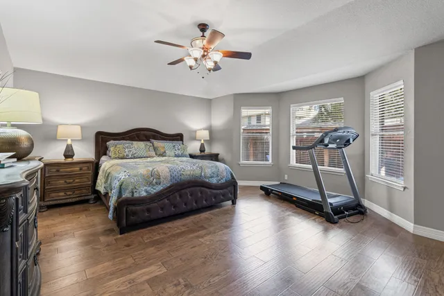 a bedroom with a bed and a chandelier
