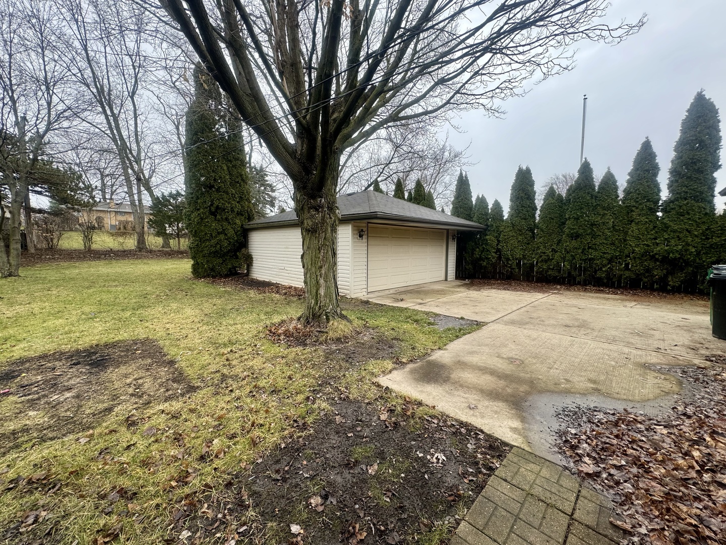 141 Warren Avenue Bloomingdale, IL 60108 - Photo 21 of 22 a yellow house with trees in front of it