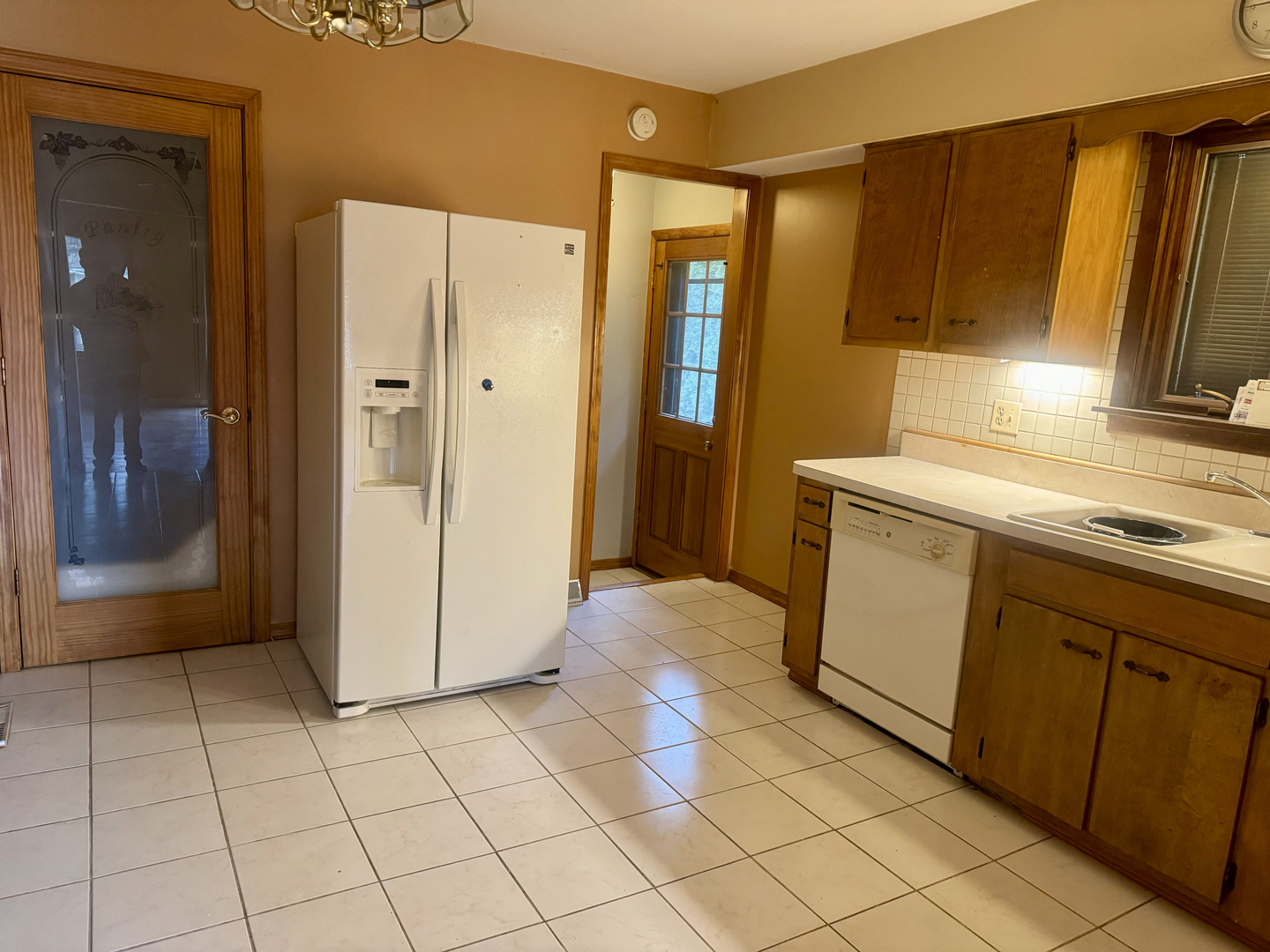 141 Warren Avenue Bloomingdale, IL 60108 - Photo 5 of 22 a kitchen with a refrigerator sink and cabinets