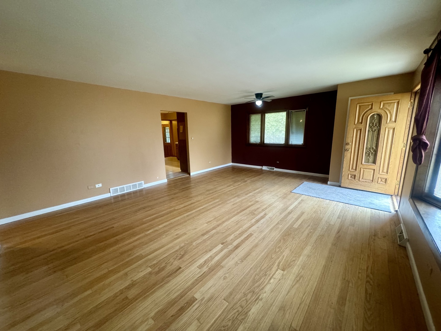 141 Warren Avenue Bloomingdale, IL 60108 - Photo 6 of 22 a view of an empty room with window and wooden floor