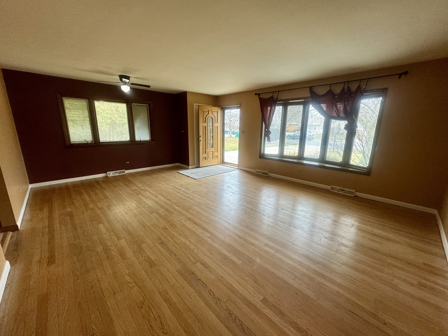 141 Warren Avenue Bloomingdale, IL 60108 - Photo 7 of 22 a view of an empty room with wooden floor and a window