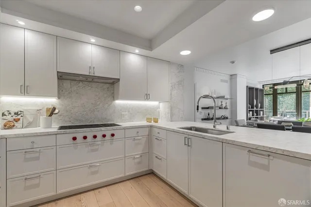 a kitchen with sink and white cabinets