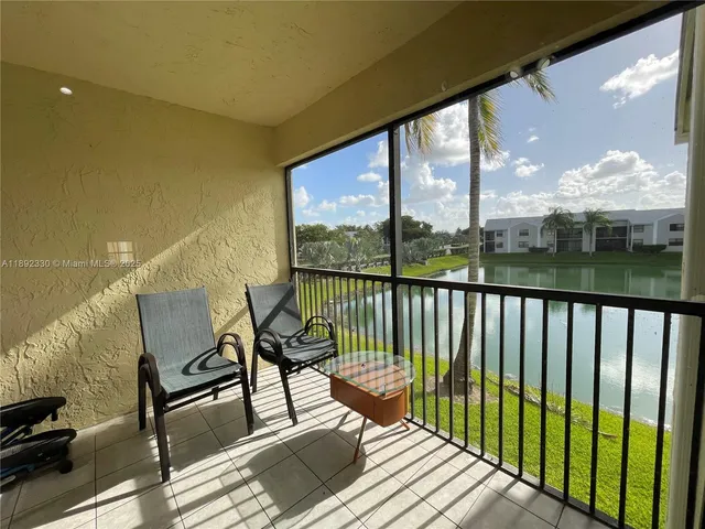 a view of a balcony with furniture and wooden floor