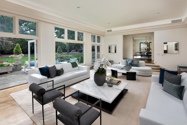 a living room with furniture large window and outer view