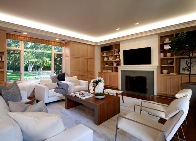 a living room with furniture a fireplace and a flat screen tv