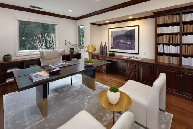 a work room with furniture and a bookshelf