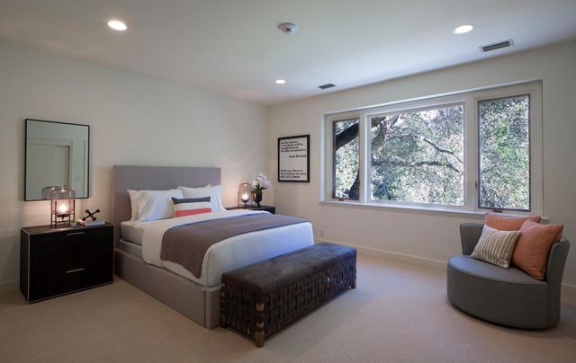 a bedroom with a bed and a couch