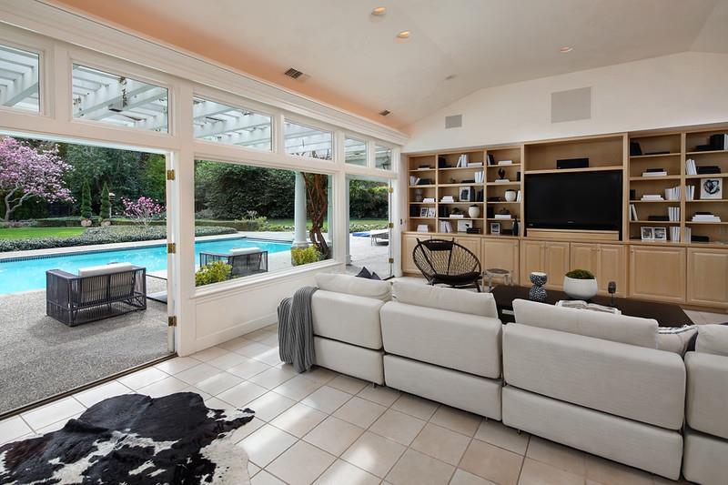 191 Britton Avenue Atherton, CA 94027 - Photo 22 of 23 a living room with furniture a flat screen tv and floor to ceiling window