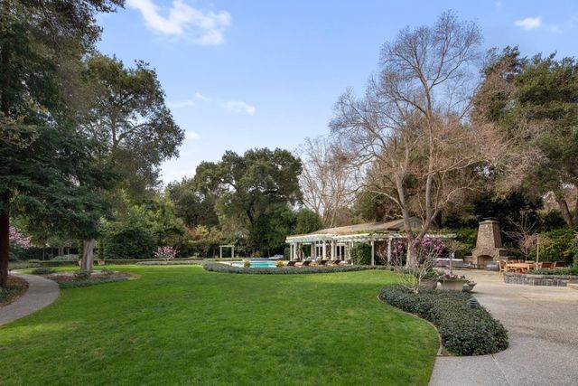 a view of a yard with swimming pool and sitting area