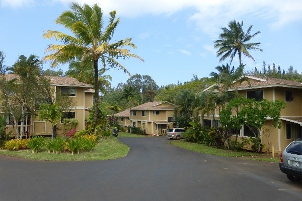4800 Hanalei Plantation Road, Unit 5A Princeville, HI 96722 - Photo 1 of 20 a front view of a house with a garden and parking