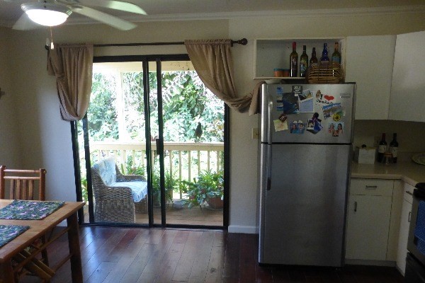 4800 Hanalei Plantation Road, Unit 5A Princeville, HI 96722 - Photo 17 of 20 a kitchen with stainless steel appliances a refrigerator and wooden floor