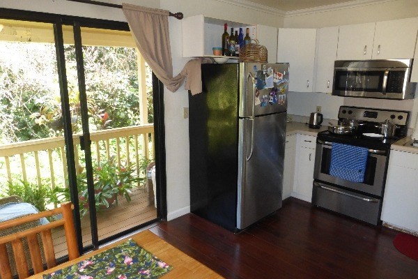4800 Hanalei Plantation Road, Unit 5A Princeville, HI 96722 - Photo 4 of 20 a kitchen with stainless steel appliances a refrigerator and a window
