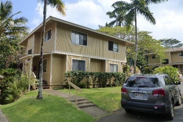 4800 Hanalei Plantation Road, Unit 5A Princeville, HI 96722 - Photo 8 of 20 a front view of a house with garden