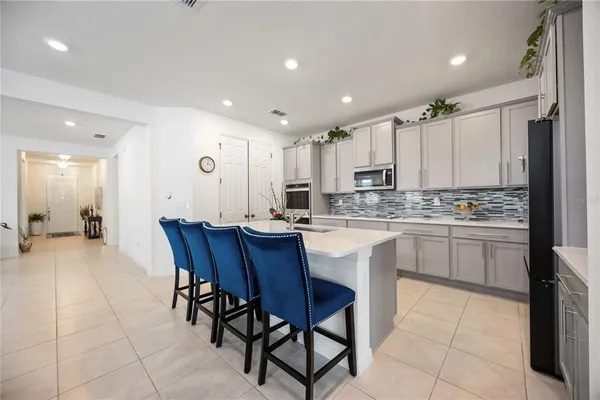 a kitchen with sink cabinets and chairs