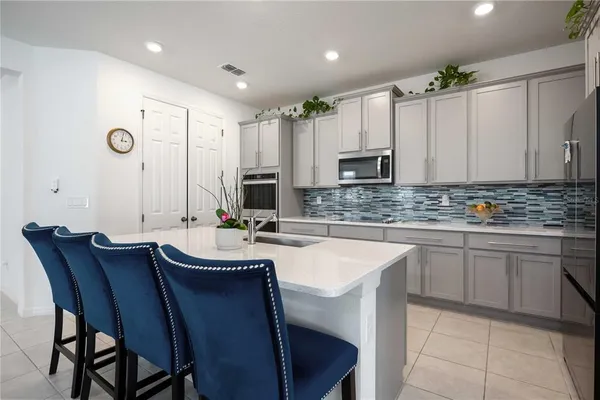 a kitchen with kitchen island granite countertop wooden cabinets and stainless steel appliances