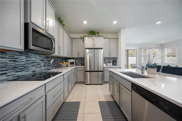 a kitchen with stainless steel appliances a sink and a refrigerator