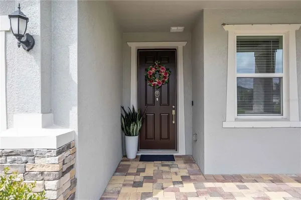 a view of a hallway to a livingroom and a window