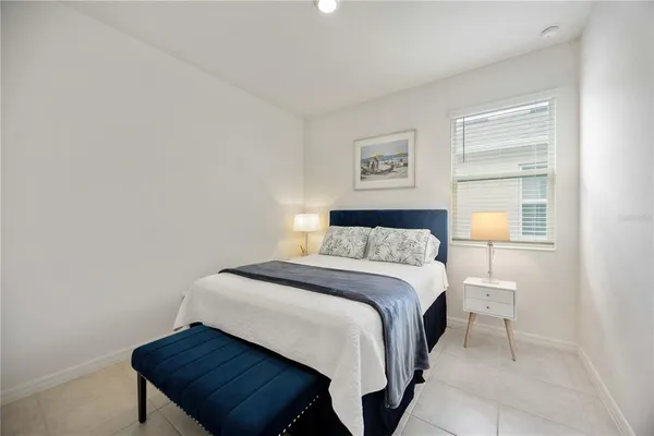 a spacious bedroom with a bed and a large mirror