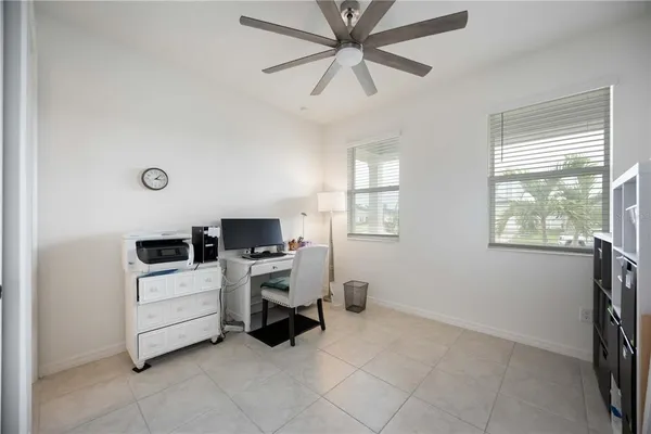 a view of a workspace with furniture and a window