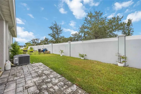 a view of a house with backyard porch and sitting area