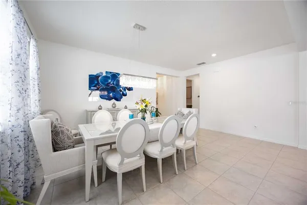 a dining room with furniture and window