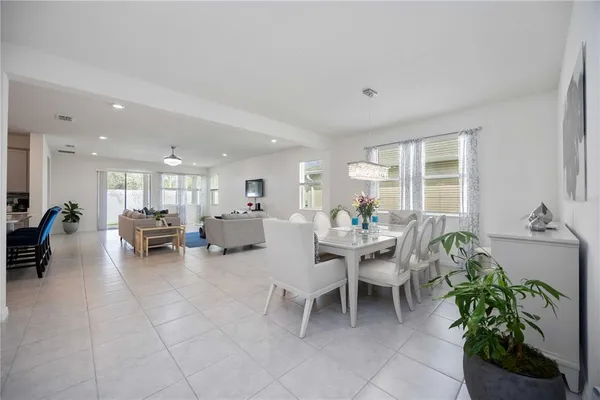 a living room with furniture and potted plants