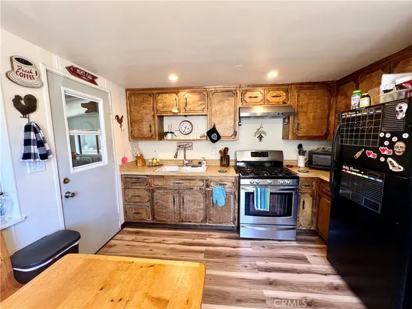 a kitchen with stainless steel appliances granite countertop a stove and a sink