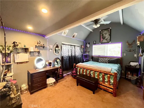 a bed room with a bed mirror and a desk