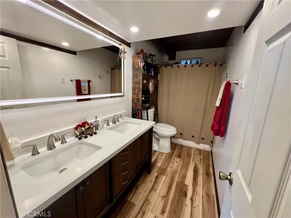 a bathroom with a sink vanity mirror and a toilet