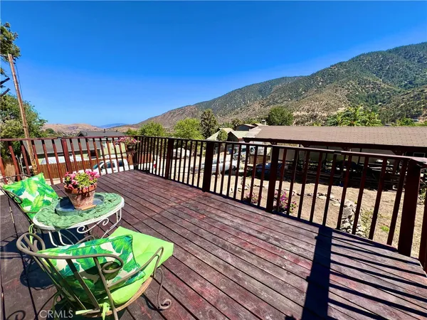 a view of a chairs and table in the balcony