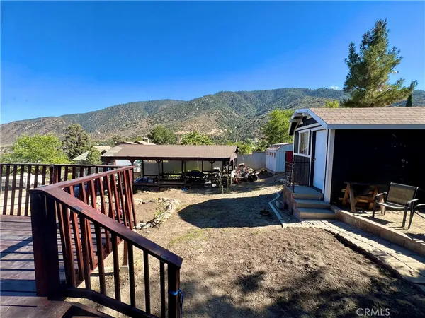a view of a balcony with chair and wooden floor