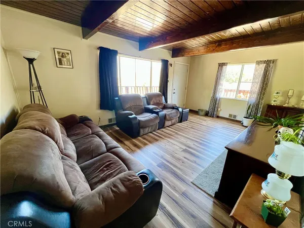 a living room with furniture rug and wooden floor