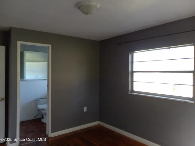 a bathroom with a shower and a glass door