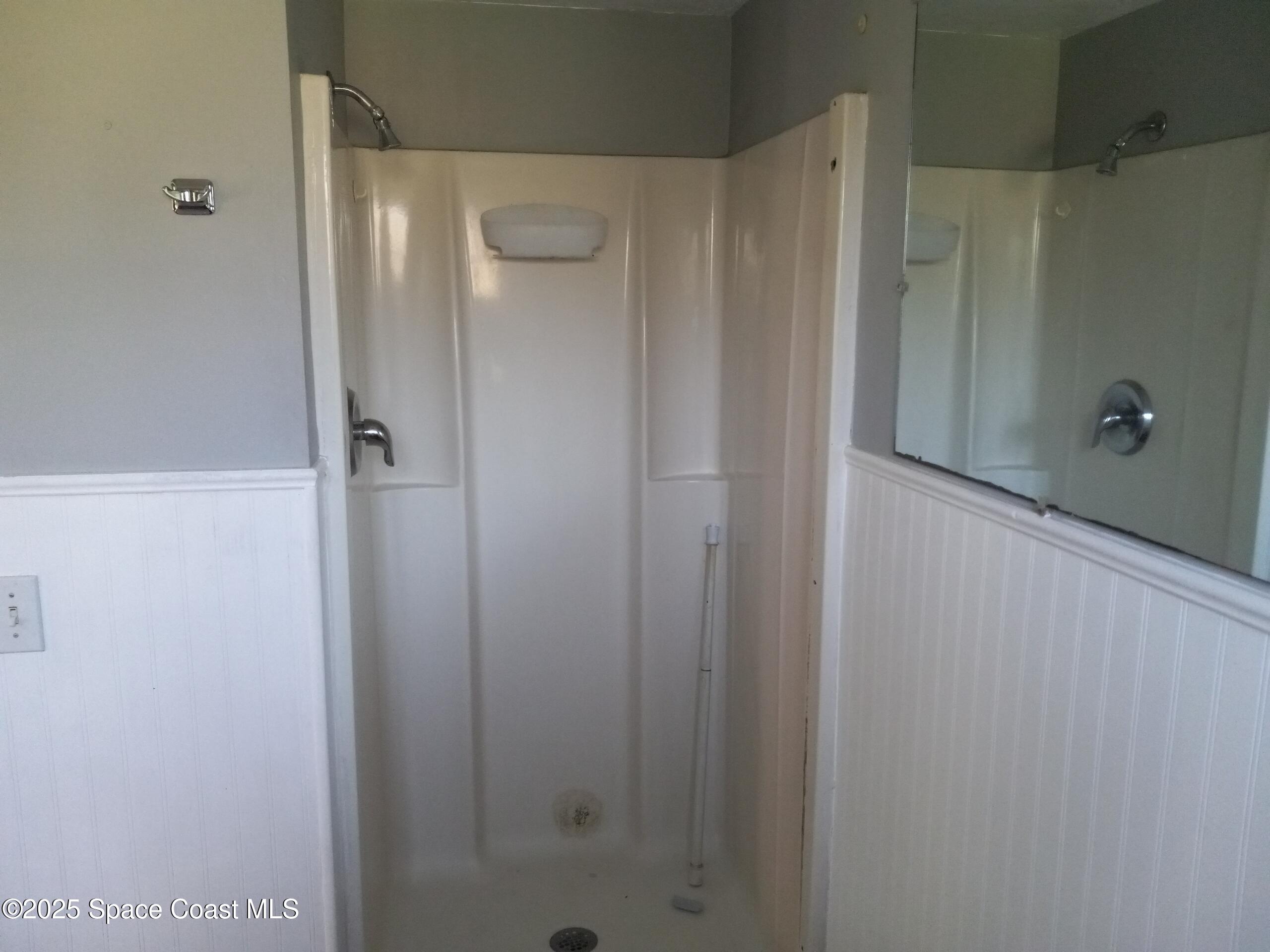 4335 Kumquat Street Cocoa, FL 32926 - Photo 14 of 21 a bathroom with a shower and a glass door