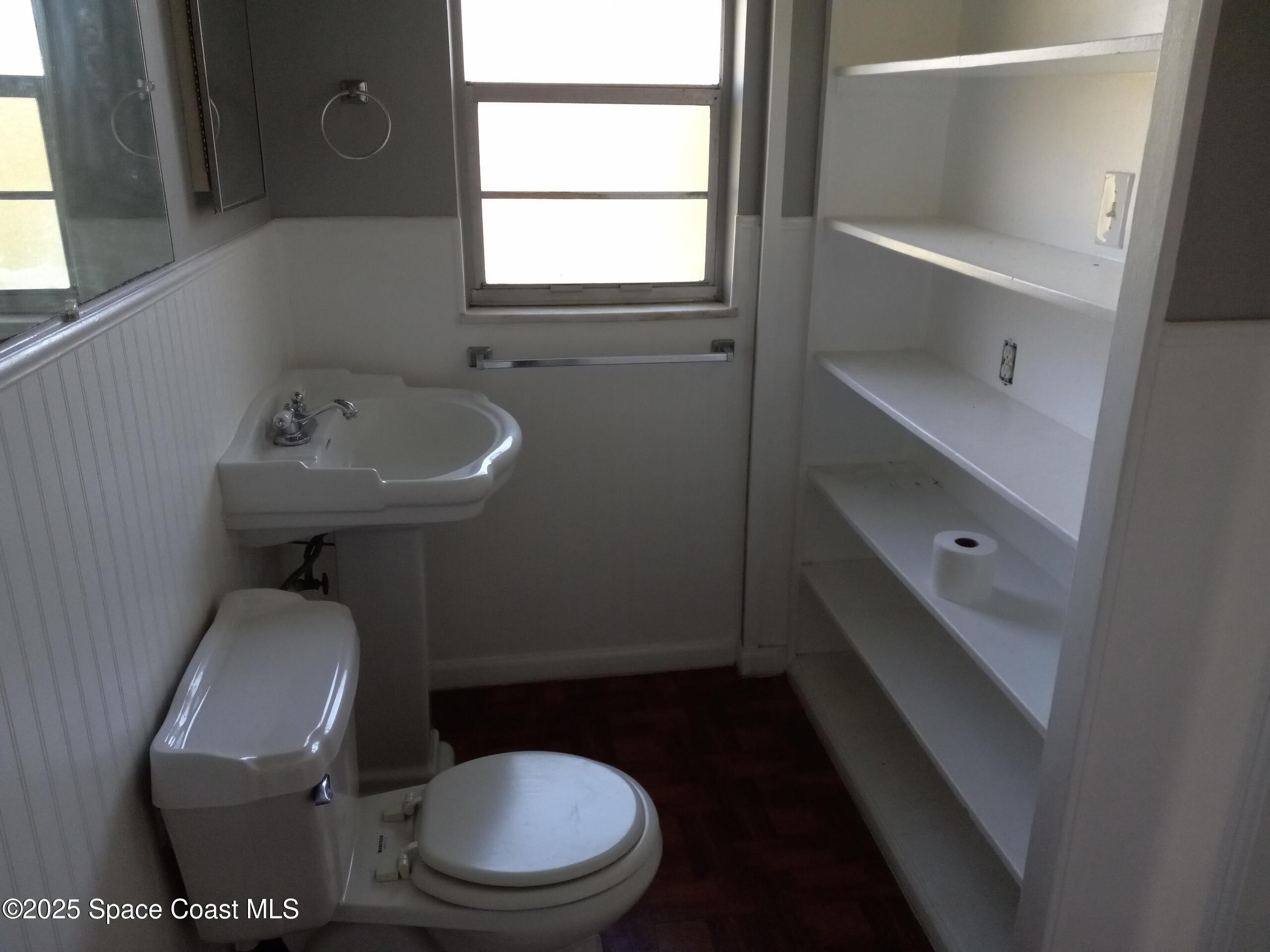 4335 Kumquat Street Cocoa, FL 32926 - Photo 15 of 21 a bathroom with a toilet a sink and a window
