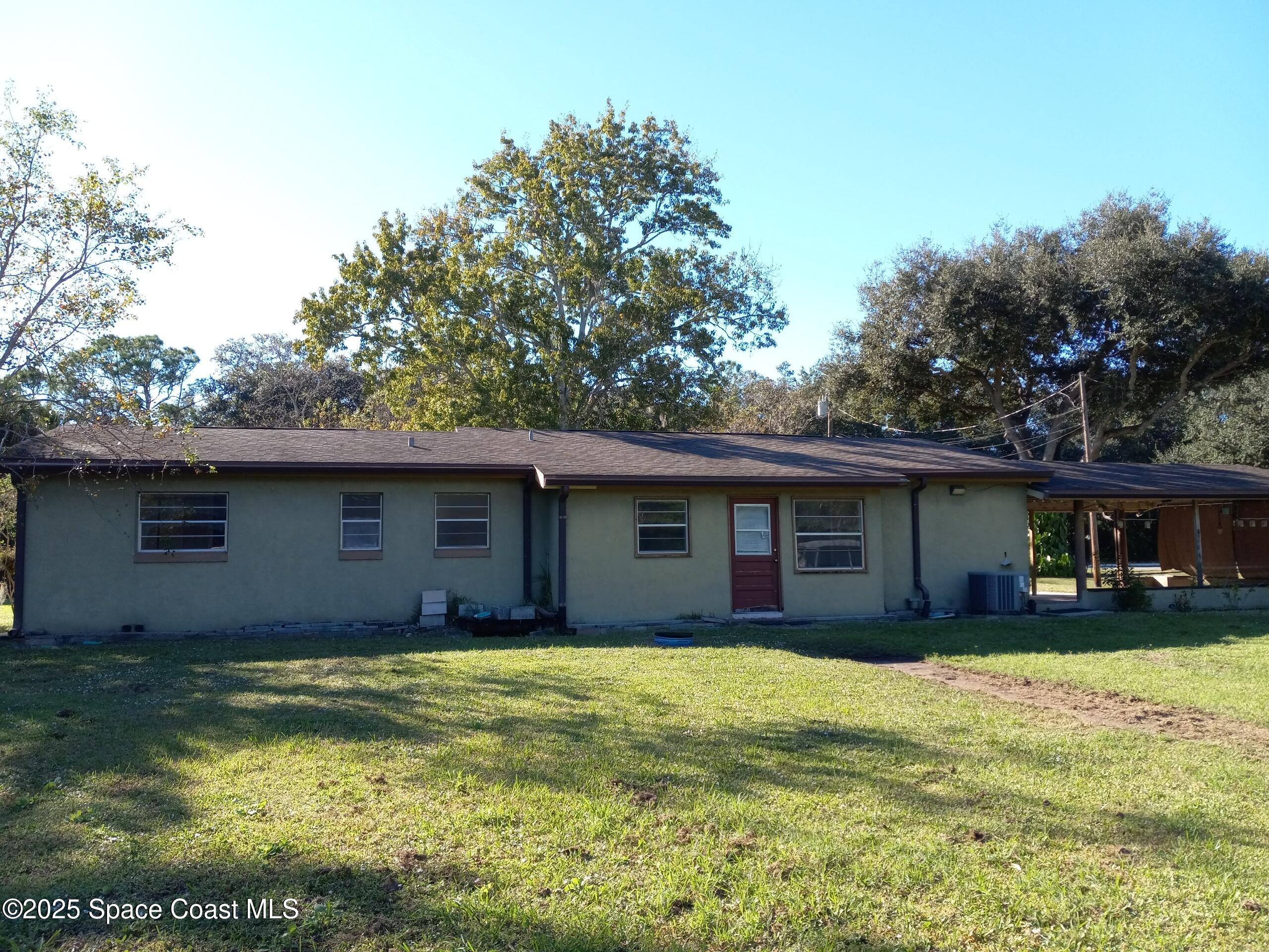 4335 Kumquat Street Cocoa, FL 32926 - Photo 19 of 21 a house with a swimming pool in front of it