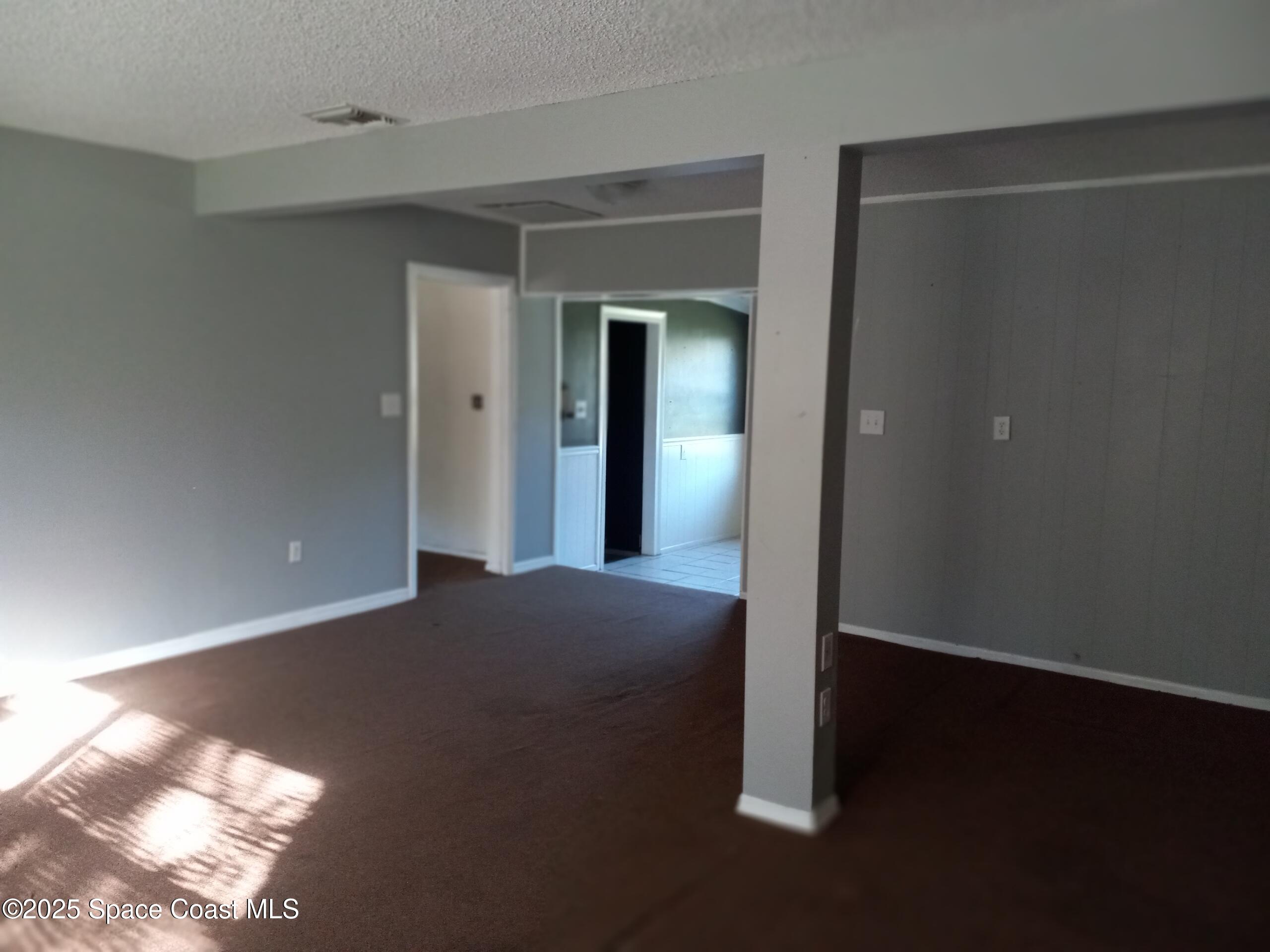 4335 Kumquat Street Cocoa, FL 32926 - Photo 5 of 21 a view of an empty room with wooden floor and a window